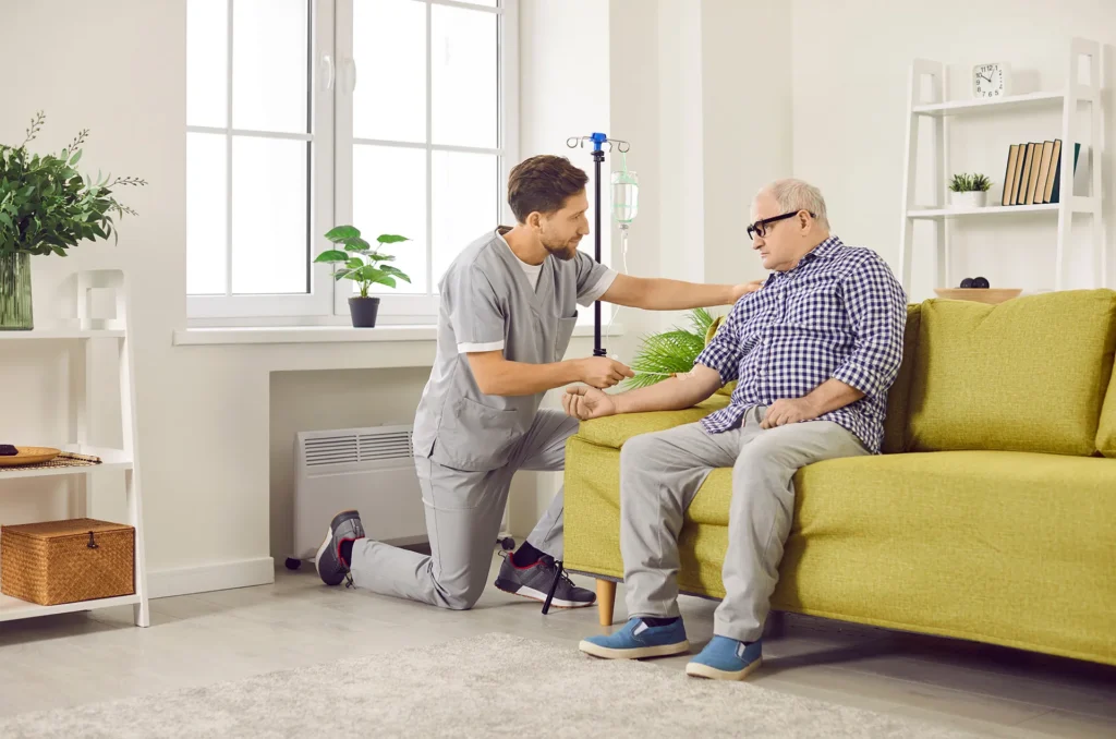 man giving patient and IV at home