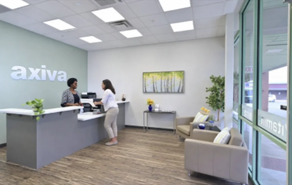 axiva office with person speaking to person at the counter